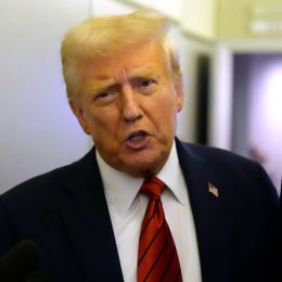 President Donald Trump speaks to reporters aboard Air Force One. His administration has issued a freeze on all government loans and grants (AP)